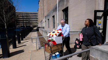 A federal worker who lost her job leaves the Department of Health and Human Services on April 1. 